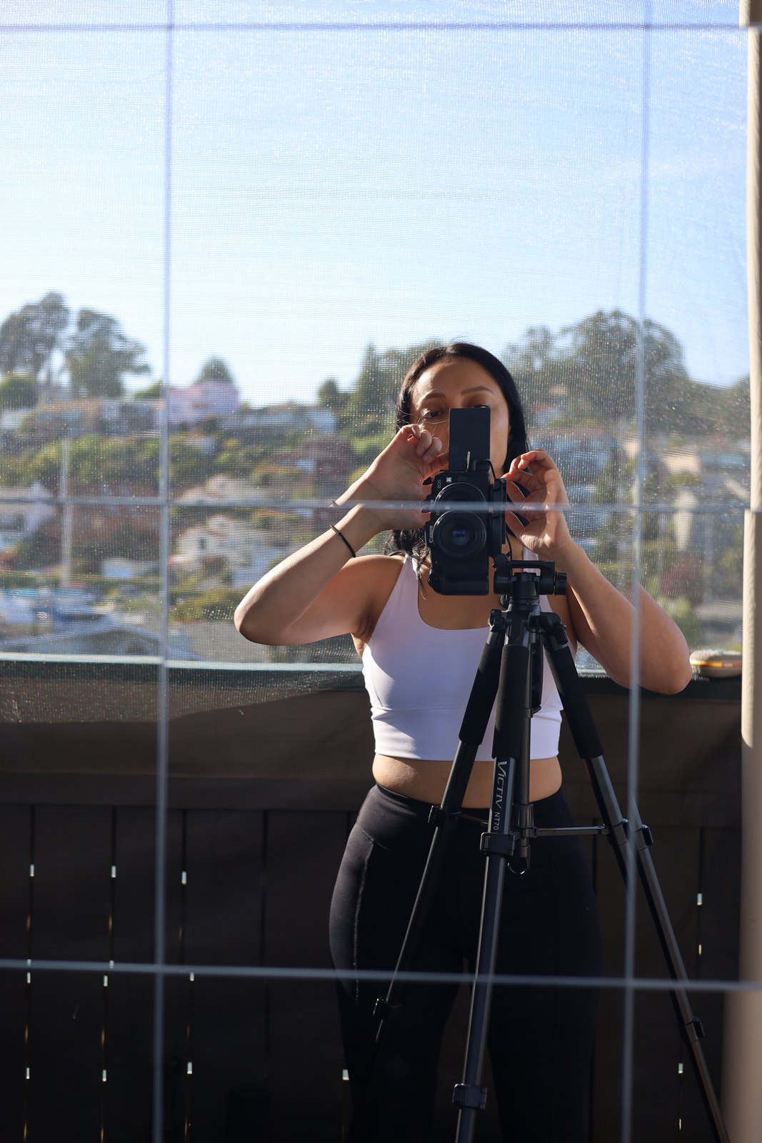 Angie behind her camera, photographing in the Bay Area